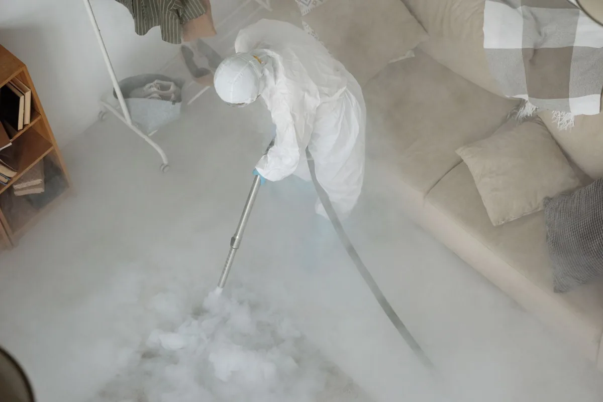 Biohazard cleanup technician in protective equipment, Newport East, RI